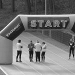 Athletes gather at the start line of a marathon, ready to begin the race.